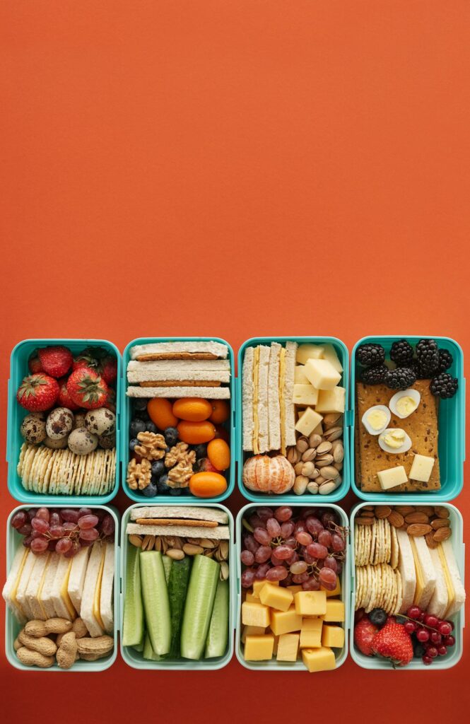 picnic food: sandwiches, fruit , nuts and berries top down shot
